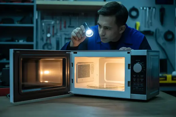 microwave being removed for repair by a professional technician