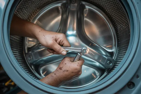 tightening bolts inside a washing machine drum